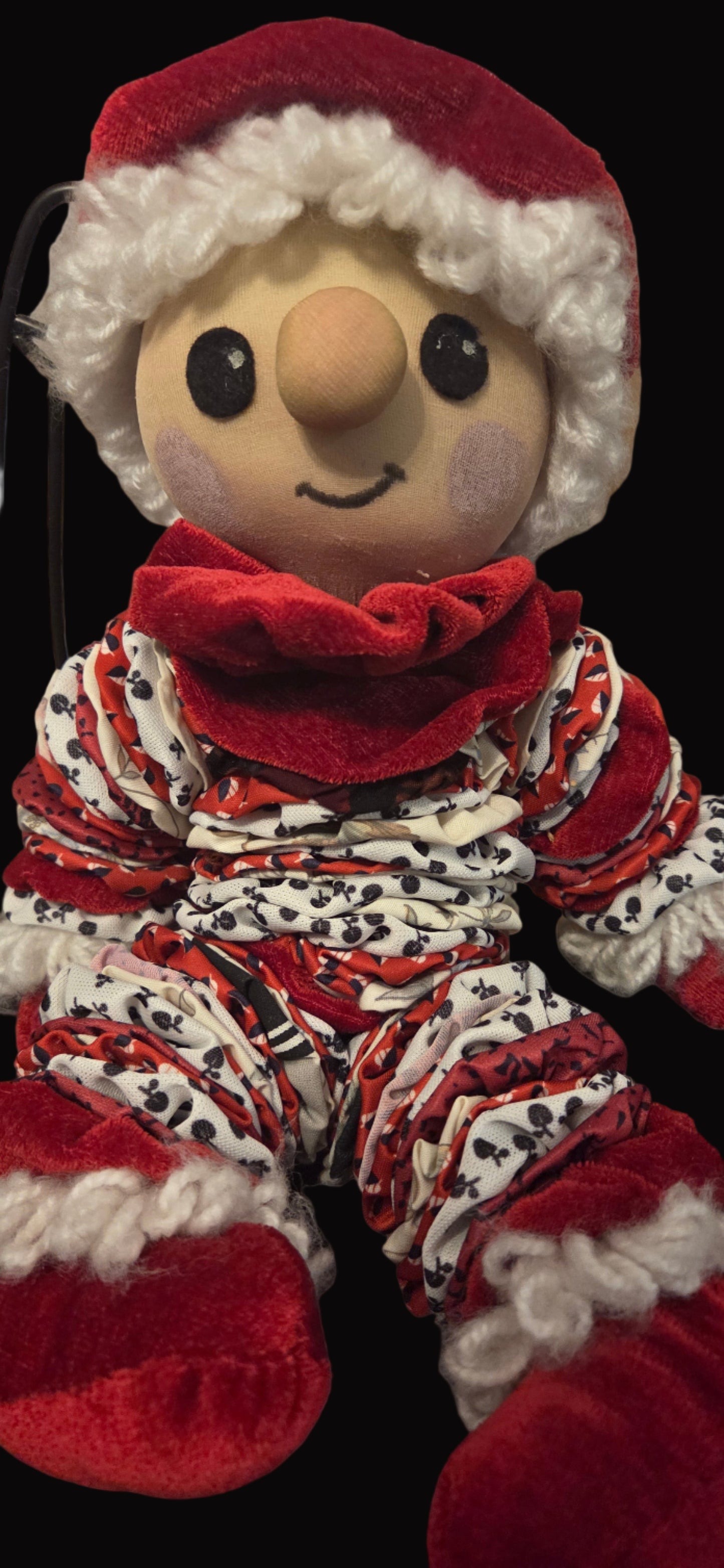 Santa Claus-themed scrunchie with red and white pattern on a black background